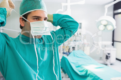 Surgeon putting his mask
