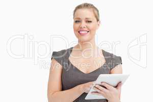 Woman smiling while using a tablet pc