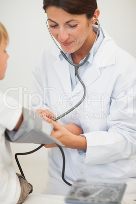 Doctor measuring blood pressure of a child