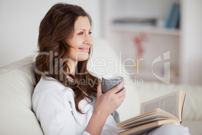 Woman looking away while sitting on a sofa