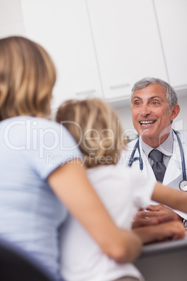 Doctor smiling to patient at his desk
