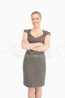 Woman standing with arms crossed on her belly