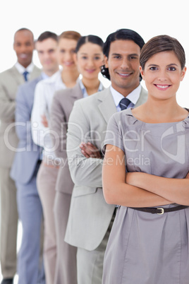 Close-up of workmates smiling in a single line