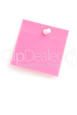 Close up of a pink adhesive note with pushpin