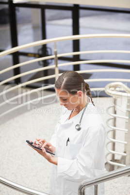 High angle view of a doctor using a tablet computer