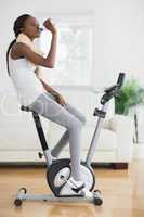 Side view of a black woman on an exercise bike