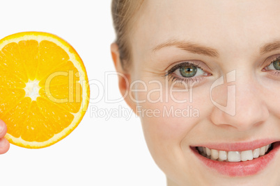 Close up of a woman presenting an orange slice