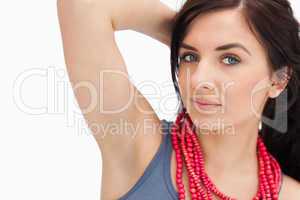 Blue eyed woman posing with a red bead necklace