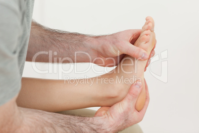 Osteopath holding the ball of a foot
