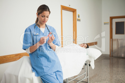 Nurse leaning on a medical bed