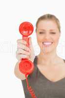 Blurred woman showing a retro phone
