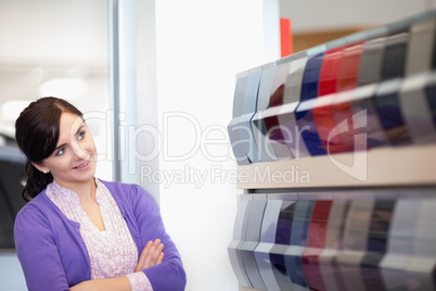 Woman crossing arms while looking at a color palette