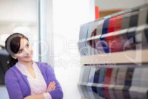 Woman crossing arms while looking at a color palette