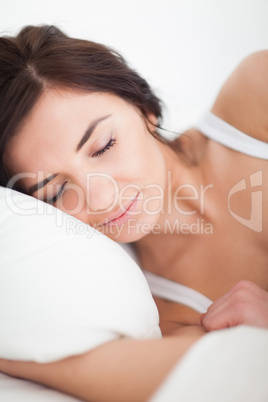 Peaceful woman lying in her bed