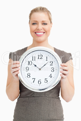 Woman holding a clock in her hands