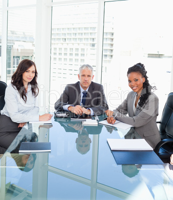 Young smiling employees communicating face to face near their di