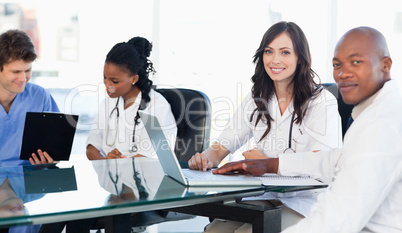 Two members of a medical team looking at the camera while workin