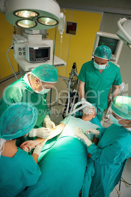 Surgeon and his team working on a patient