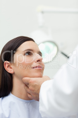 Woman patient being auscultated by a doctor