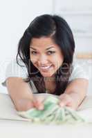 Smiling woman holding a few dollar bills