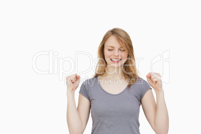 Woman clenching one's fists with closed eyes