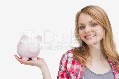 Woman holding a piggy bank on her hand