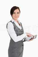 Smiling businesswoman using a touchscreen tablet