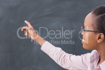 Black teacher pointing the blackboard