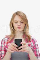 Annoyed woman using a mobile phone