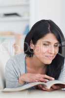 Woman laughing as she holds and touches a book