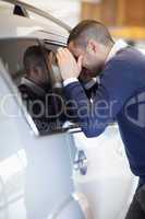 Customer looking inside a car