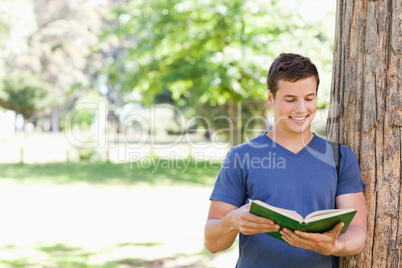 Muscled student holding a textbook