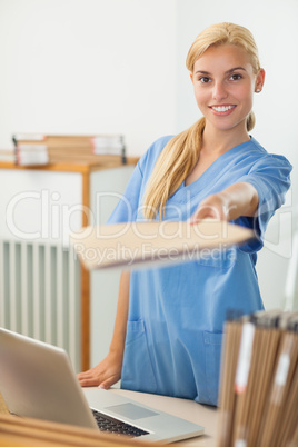 Nurse giving a folder