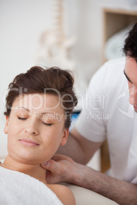 Woman being massaging her head while raising it