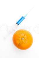 Orange next to a syringe