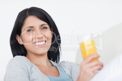 Smiling woman holding a glass of juice