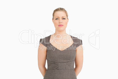 Woman standing with her arms behind her back