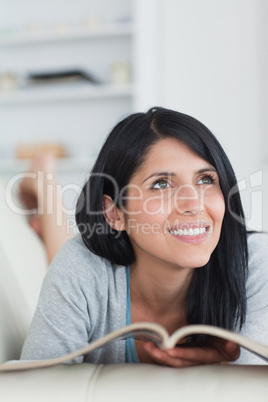 Woman smiling as she holds a magazine