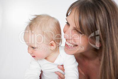 Laughing woman holding her cute daughter