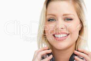 Happy blonde woman holding her headphones