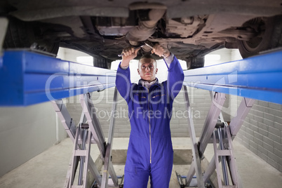 Mechanic repairing a car with tools