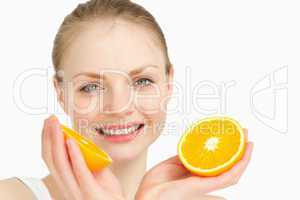 Close up of a joyful holding oranges