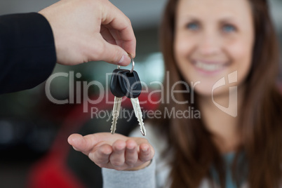 Woman smiling while receiving car keys
