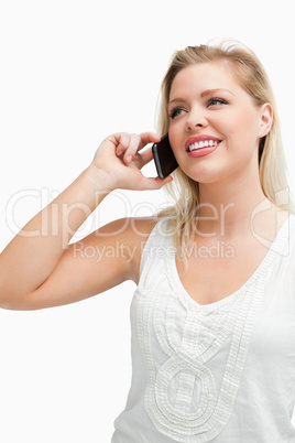 Happy woman standing while talking on the phone