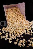 Many pop corn falling out of a box