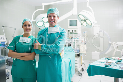 Surgeons standing up while smiling