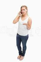 Serious blonde woman holding her mobile phone