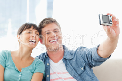 A couple laughing together as they pose for a photo
