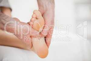 Physiotherapist using his fingers to massage a foot