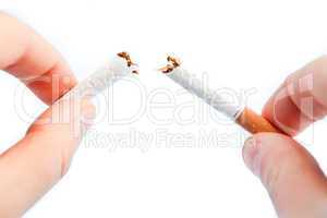 Fingers breaking a cigarette